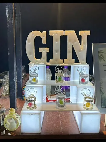 Another view of our illuminated Gin Bar. This setup features pre-garnished glasses and small, glowing jars holding different botanicals, creating an inviting and interactive experience for guests.