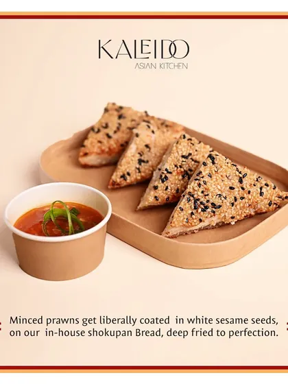 Four pieces of our signature prawn toast, ready for delivery. The toast is made with minced prawns on our house-made shokupan bread and coated liberally in white and black sesame seeds.