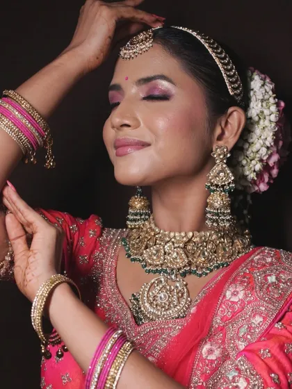 An artistic pose that highlights the beautiful makeup and traditional jewelry.