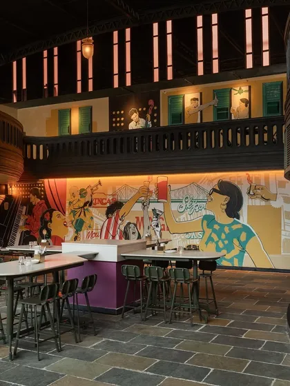 The custom mural is a central part of the restaurant's storytelling. It depicts scenes of celebration and joy, reinforcing the "Jollygunj" concept and adding a layer of artistic detail.
