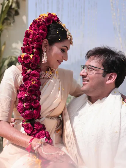 An intimate moment between the bride and groom. Her makeup is soft and romantic, and her floral braid is a stunning statement piece.