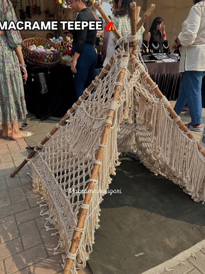 Our large macramé teepee, set up at an outdoor market. This is a unique and fun statement piece, perfect for kids' rooms, play areas, or even as a photo prop.