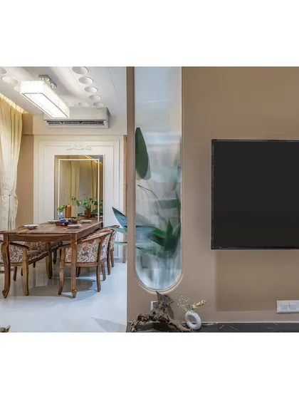 A view showing the TV unit in relation to the dining area, demonstrating how we design elements that connect and define different spaces.