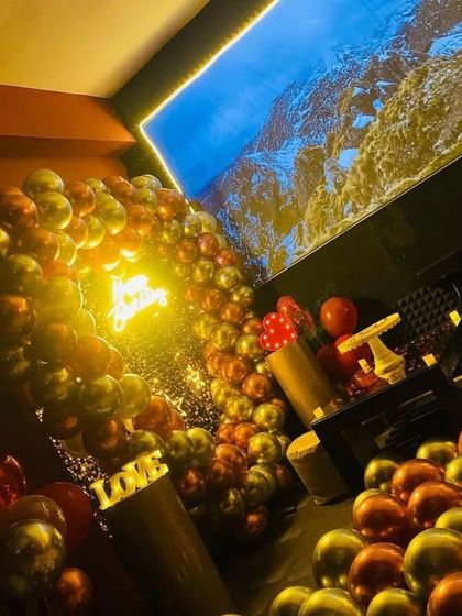 The entire theatre space is transformed for a birthday. This shot shows the decorated area with the big screen ready for the party to start.