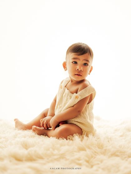 Another example of a high-key portrait, this time with the baby looking directly at the camera with a soulful gaze.