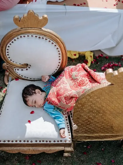 Sometimes, a long wedding day is just too much for the little ones. This adorable shot of a child napping on a chair amidst the festivities is a real and heartwarming moment.