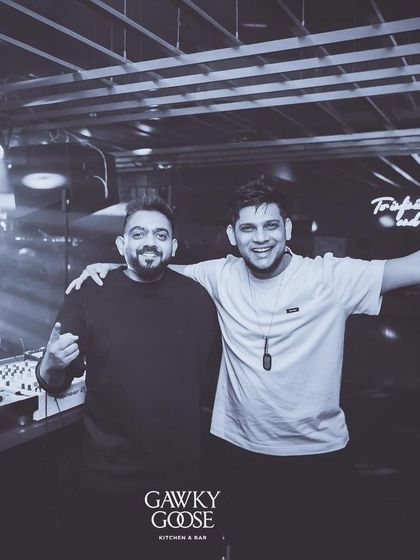 A black and white photo with a fellow DJ, capturing a moment of camaraderie.