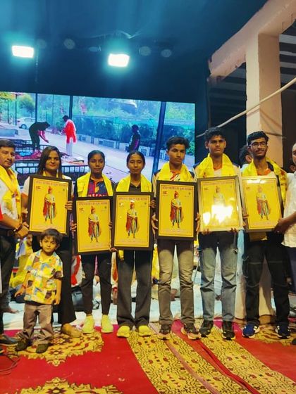 Our team of athletes being felicitated on stage during a community event celebrating their success in track and field.