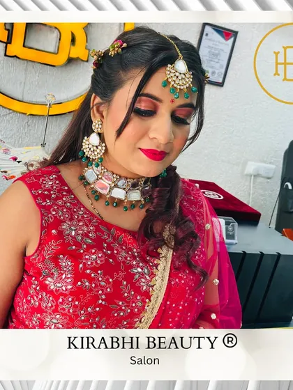 This client is ready for a wedding celebration. Her makeup is bold and festive, and her hair is styled in a half-updo to show off her beautiful jewelry.