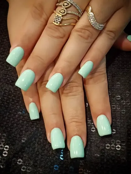 A fresh and simple set of square-shaped nails in a lovely pastel mint green color.