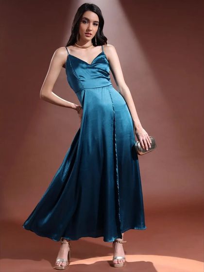 A beautiful teal satin gown styled for maximum elegance. I paired it with a classic clutch and gold heels, letting the dress flow to create a sense of movement and luxury.