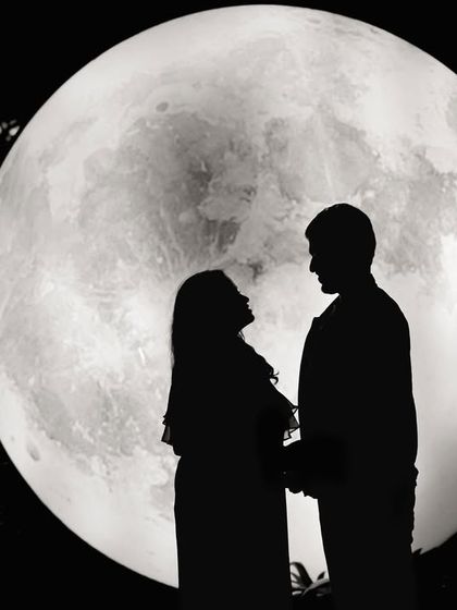 A romantic silhouette of an expecting couple against our giant moon prop, a beautiful way to capture the magic of pregnancy.