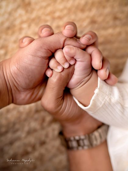 A close-up of a family's hands, a symbol of their connection and love.