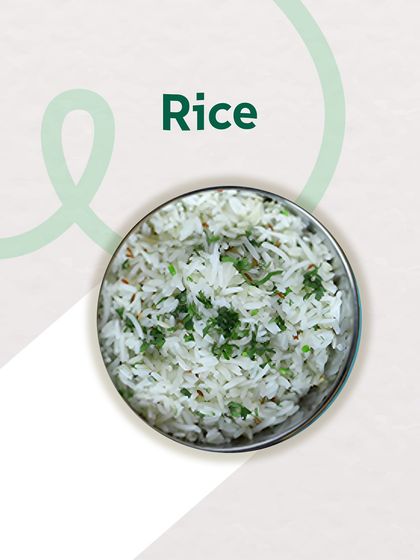 A simple bowl of steamed rice, garnished with fresh coriander. It's the perfect canvas for my flavorful dals and sabzis, a staple in every tiffin.