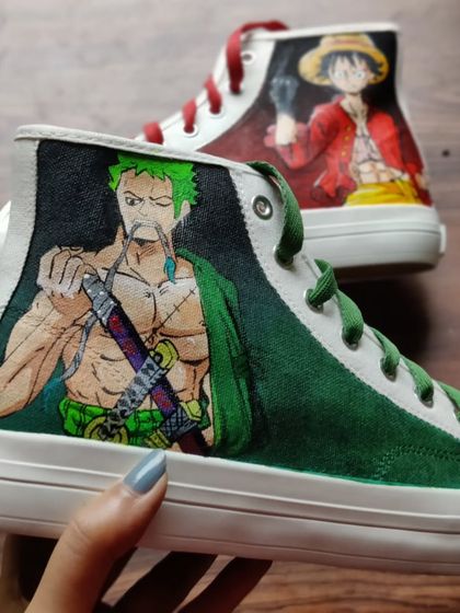 A close up of the Zoro and Luffy custom high-tops. You can really see the detail and line work that goes into capturing the characters' expressions and energy.