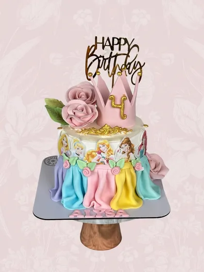 A cake fit for royalty. This Disney Princess cake for a 4th birthday features beautiful fondant drapes in each princess's signature color and is topped with a golden crown.