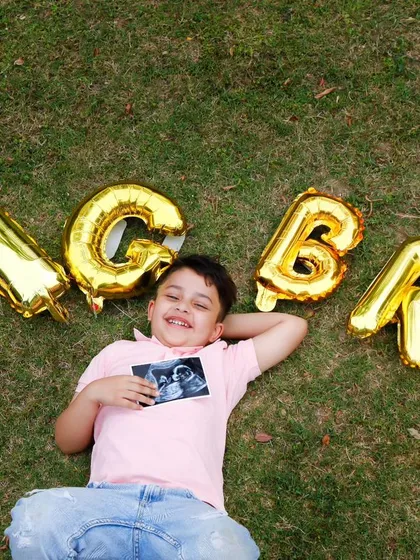 A creative and joyful pregnancy announcement. The "BIG BRO" balloons and the sonogram picture tell a beautiful story of a growing family.