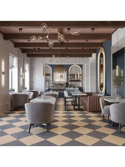 This cafe design has a classic European feel, with a checkered floor, exposed ceiling beams, and elegant grey armchairs. The space feels bright, airy, and timeless.