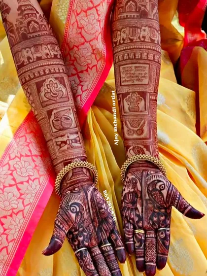 A rich and dark bridal mehndi stain, showcasing peacock figures on the palms and traditional symbols like Ganesha and kalash on the arms.