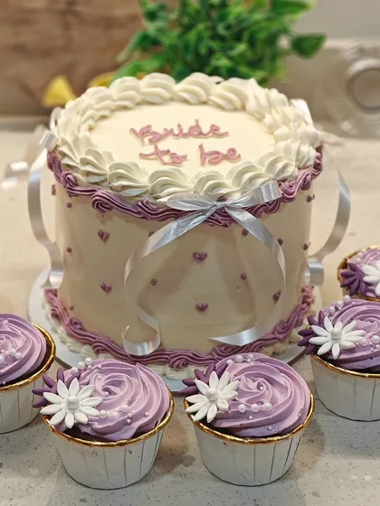 I'm obsessed with vintage cakes, and this "Bride to be" design is a perfect example. I used intricate piping techniques and delicate ribbons to create this elegant look for a special bridal shower. The flavor inside is my popular white chocolate and mixed berries.