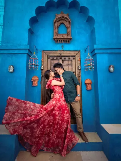 Don't be afraid to play with prints and colors. This red floral organza gown has a beautiful, airy flare that brings a touch of playful romance to your pre-wedding photos.