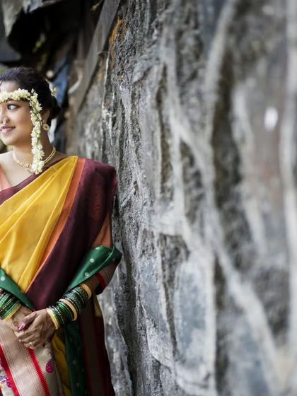 A thoughtful portrait of the bride against a rustic stone wall, creating a timeless image.