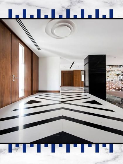 A bold and modern flooring design using black and white marble in a striking chevron pattern. This is how we use flooring to make a powerful design statement.