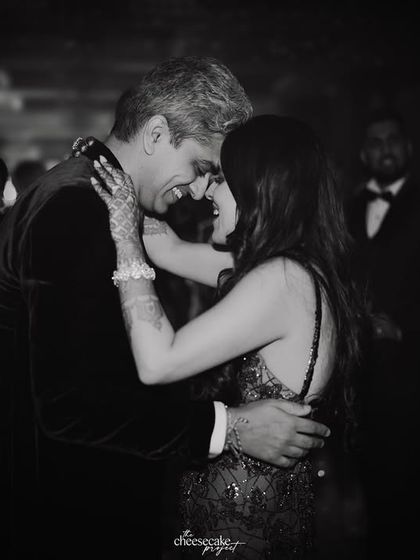 An intimate black and white photo of the couple slow dancing, lost in the moment.