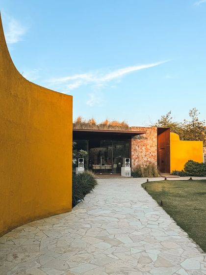 The path to our pavilion is a journey in itself, with curved walls that gently guide you toward a space of relaxation and community.