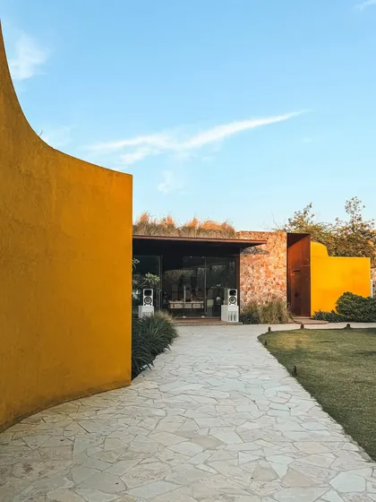 The path to our pavilion is a journey in itself, with curved walls that gently guide you toward a space of relaxation and community.
