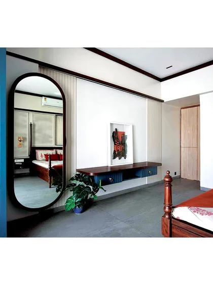 Another perspective of the statement dresser mirror, showing how it enhances the room's light and provides a full view of the space.
