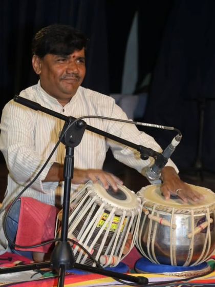 Our tabla guru accompanies the vocal trio, providing the essential rhythmic framework for the performance.