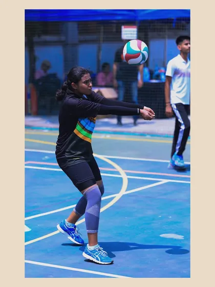 A female player executes a pass with perfect form. Her focus and technique are a result of dedicated practice and expert coaching.