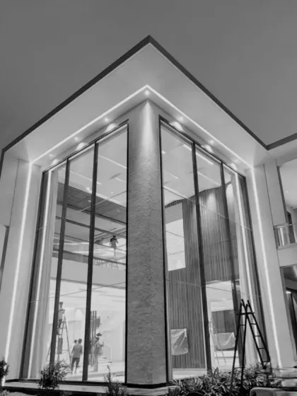 A glimpse of our upcoming residence, featuring seamless transitions from facade to interiors. The double-height glass facade creates a sense of transparency and grandeur, redefining modern living.