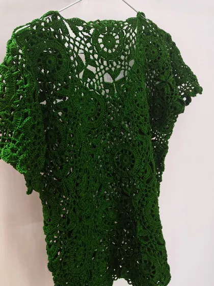 This is my signature green lace top, a piece that holds so much of my heart. It's crafted from over 45 individual hexagon motifs using pure, breathable cotton yarn. Each motif takes time and focus, but seeing them come together into this intricate, wearable piece of art makes all the effort worthwhile.