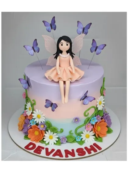 A whimsical fairy garden cake with an eggless chocolate truffle flavor. This design features a beautiful handmade fairy topper sitting amongst a field of colorful fondant flowers.