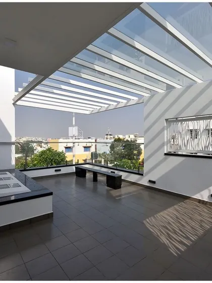 This semi-covered terrace demonstrates our focus on creating usable outdoor spaces. The pergola creates a beautiful play of light and shadow, making it a perfect space for relaxation.
