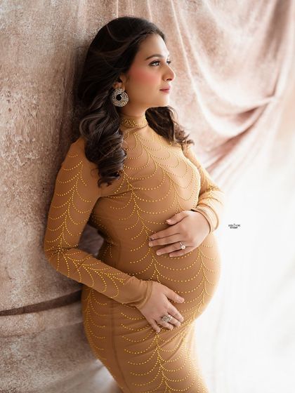 A classic window-lit portrait. The soft light and the warm tones of her dress create a beautiful, gentle glow.
