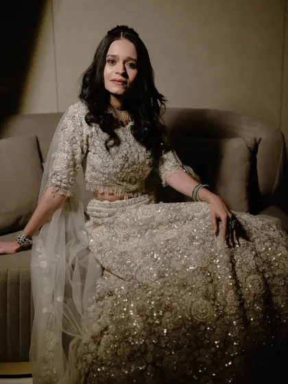 A stunning portrait of the bride in a heavily embellished silver lehenga. This shot is all about glamour and sophistication.