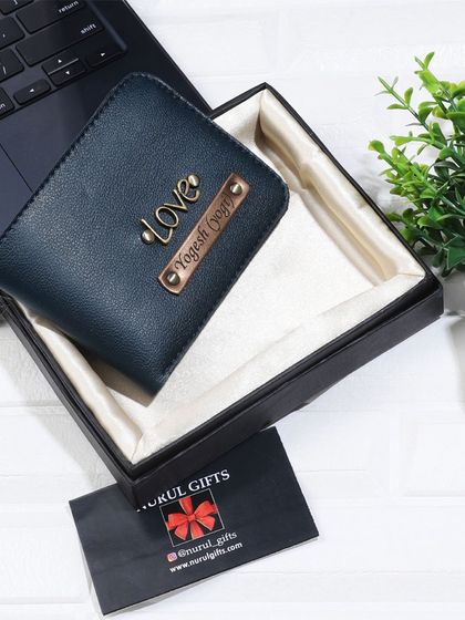 This personalized wallet in a deep teal color is customized with a 'Love' charm and presented in a gift box.