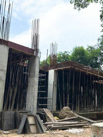 The concrete columns and slabs of the Shantiniketan project taking shape. This image documents the raw, powerful beauty of a building in its nascent phase.