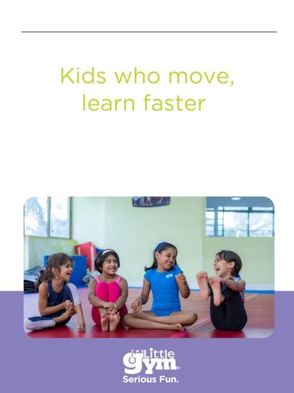 Kids who move, learn faster. This picture of four girls sharing a laugh during a stretching exercise illustrates how physical activity fosters social bonds and prepares the brain for learning.