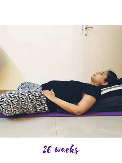A supported Reclining Bound Angle Pose (Supta Baddha Konasana) at 26 weeks is perfect for rest and relaxation.