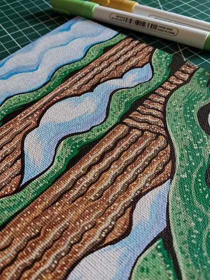 A different angle of the landscape painting, showing the texture of the canvas and the layers of marker ink.
