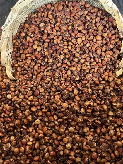A basket overflowing with dried Sumac berries, a key ingredient for adding a natural, zesty flavor to our food.