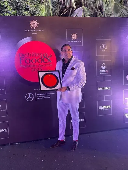 Posing with the 2023 'Caterer of the Year' award. Consistency is key, and we are proud to be recognized year after year for our high standards.