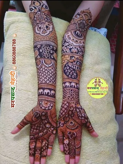 An intricate full-arm design with a variety of traditional motifs, including elephants and peacocks. The dense patterns are perfect for a bride who wants a heavy, classic look.