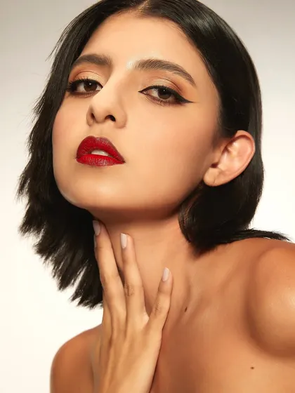 Fresh skin paired with a bold, classic red lip. This look from a student's first portfolio shoot is timeless, confident, and perfectly executed.