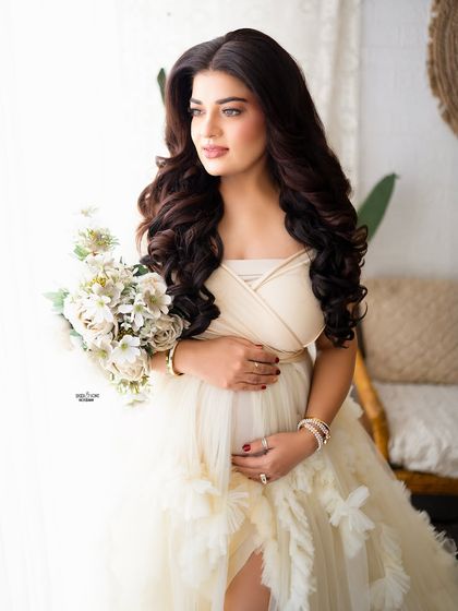 What a beautiful mamma. This stunning ruffled off-white gown looks incredible in our bright and airy boho studio setup.