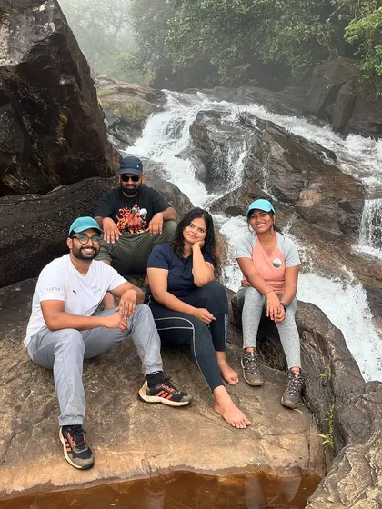 A small group relaxing by a waterfall during the Bandaje trek. These breaks are perfect for cooling off and enjoying nature.